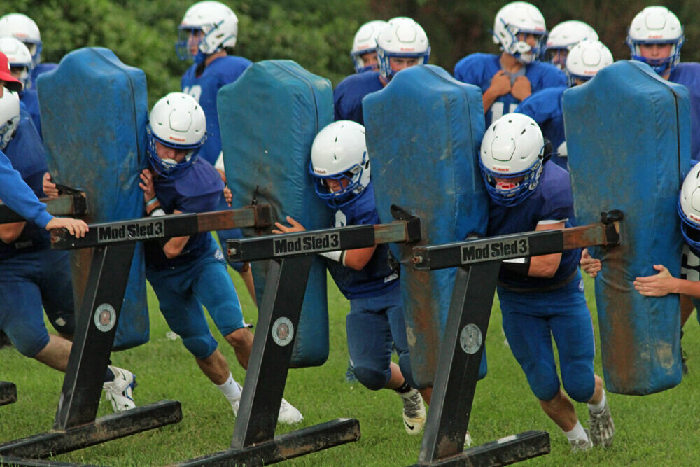 Members of the Scotland County football team run a drill in practice on Aug. 14. 