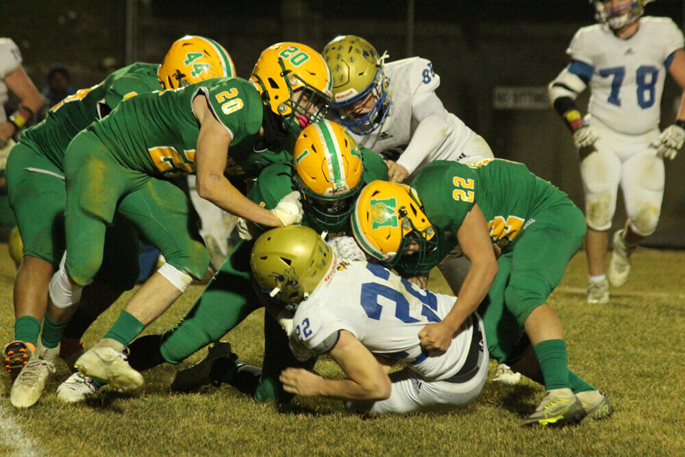 The Milan defense works to bring down a Penney ballcarrier in the game on Nov. 17. 