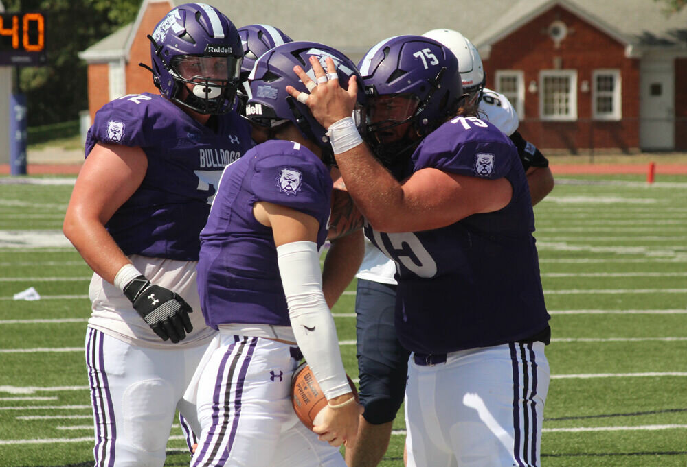 Truman offensive lineman Dane Eggert (75) celebrates with quarterback Dylan Hair after Hair's rushing touchdown in the game against South Dakota Mines on Sept. 9.