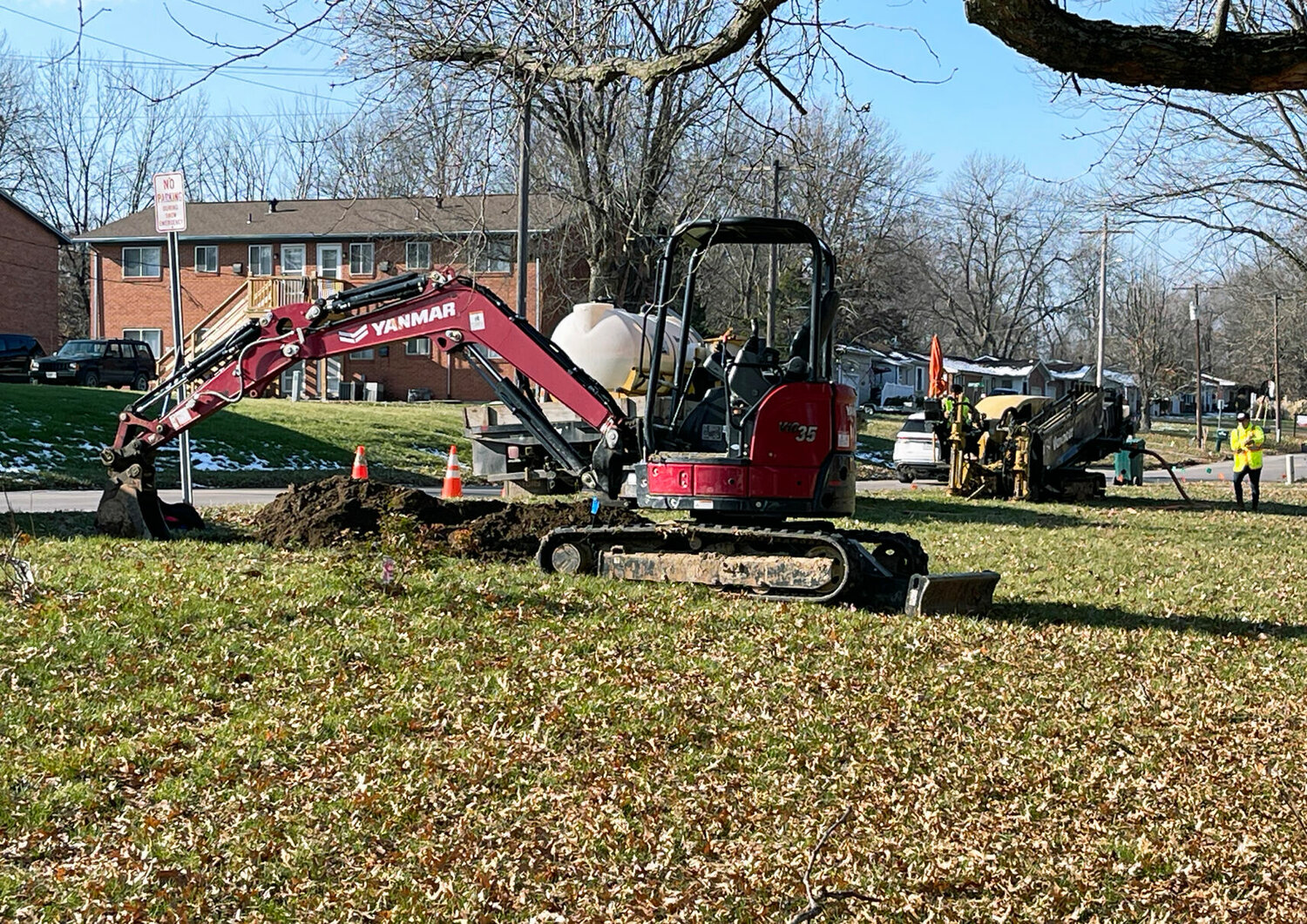 Holes were dug in a yard on East LaHarpe Street, Thursday, Nov. 30, as a fiber line will be buried along the street.