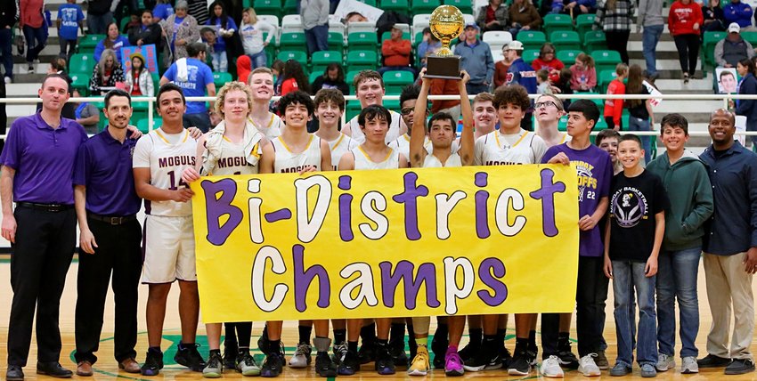 Munday basketball team proudly displays Bi-District Championship banner and trophy. See sports for more results.