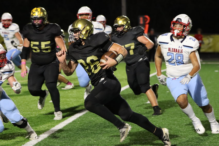 Lebanon senior Nathan Bartel rushes the ball during a high school football game against the Glendale Falcons on Friday night.