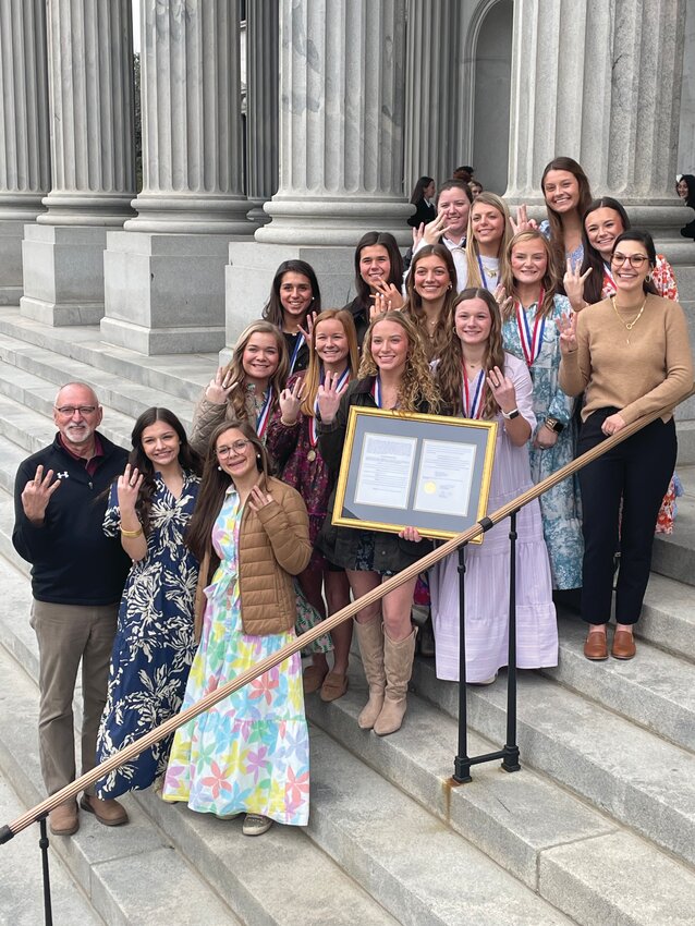 The Clarendon Hall Varsity Softball team poses with Rep. Fawn Pedalino on the steps of the South Carolina State House after being recognized for winning their third consecutive SCISA 2A state championship.