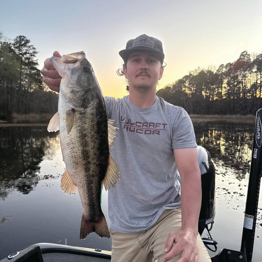Wyatt Sims of Timmonsville, S.C., holds up the tagged largemouth bass he caught on Lake Marion, earning him a $1,300 payout as the first winner in the Bonus Bass tournament.