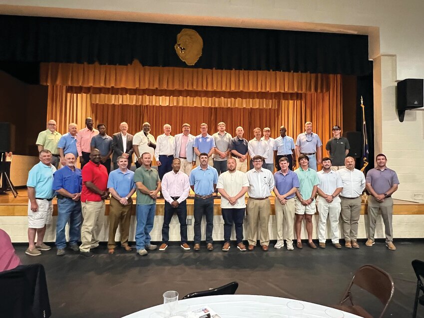 Dozens of former players from American Legion Post 68 and local high schools gathered on stage with Coach Bill Brewer during a tribute evening in his honor.