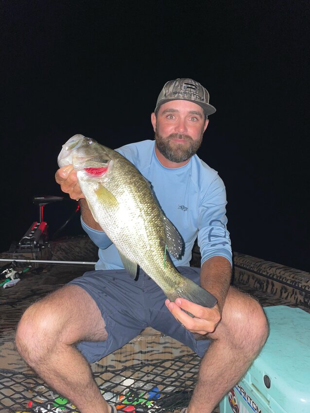 David Ardis of Sumter holds the three-pound tagged bass he caught in Taw Caw Creek during a night fishing trip, earning a $4,400 payout as the final registered winner in the 2024 Bonus Bass tournament.