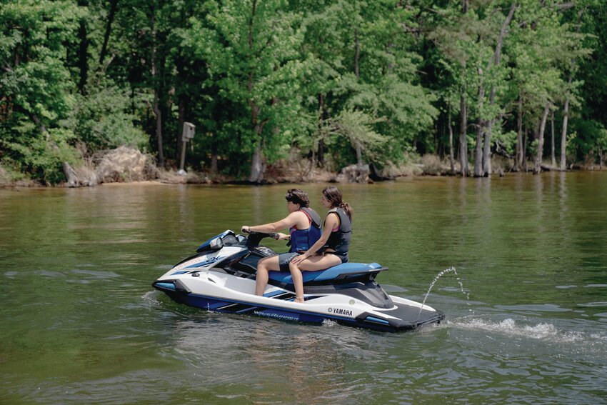 Two riders wearing life jackets operate a personal watercraft. SCDNR reminds all jet ski operators to follow safety regulations, including using a kill switch lanyard and operating only during daylight hours.