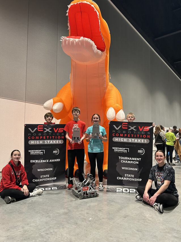 Lomia state champion robotics team poses with their championship trophies, banners, and robot. The team conisisted of  Sammie Rhodes, Prentice Reitz, Abram Keiler, Della Emmer, CJ Binkelman, Makenna Caspoer.