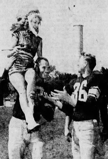 The Packers Tobin Rote “passes” Lumberjack Band Head Majorette Mary Jane Van Duyse to Bill Howton at Stevens Point training camp in 1955.