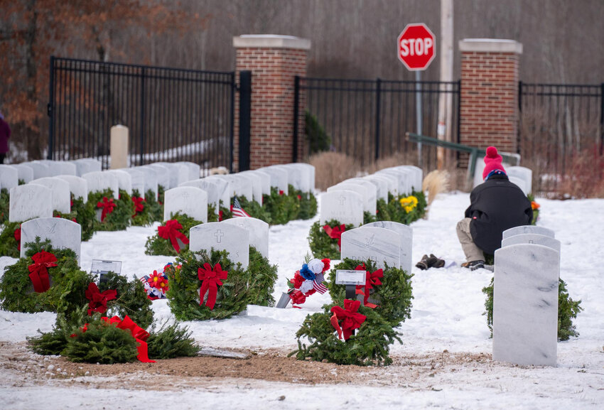 Someone places a wreath at the Wisconsin National Veterans Cemetery in Harshaw, speaks aloud a name, and pauses for a solemn moment.