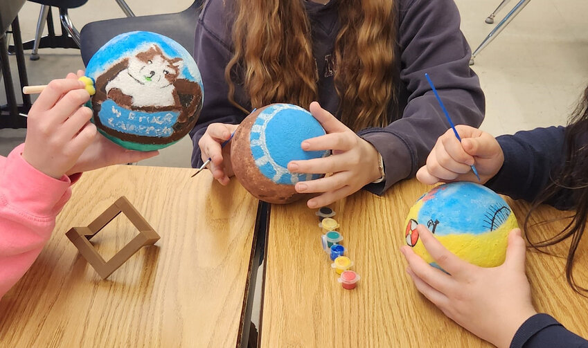 St. John eighth grade art students create moon lamps depicting their favorite books.