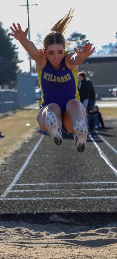 Casey Hartman of Wild Rose long jumping during the track meet.