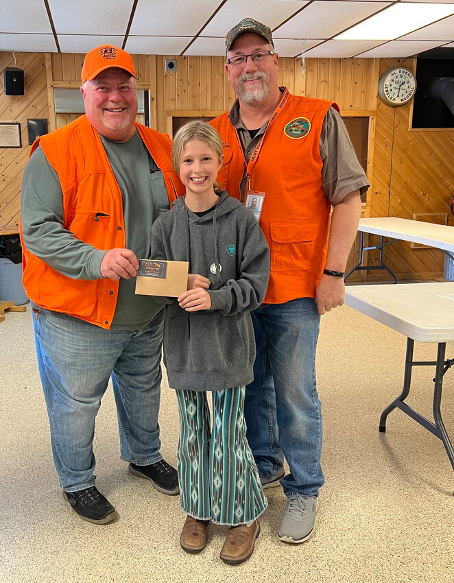 President Mike Honerlaw and lead Hunter Safety instructor Tim Fischer with the winner of the raffle held after Hunter Safety.