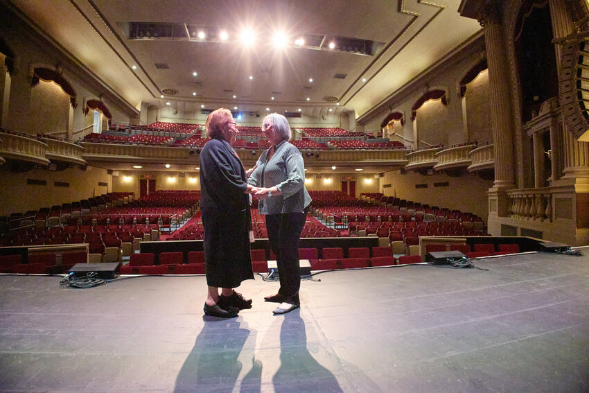 Eva Zaret, left, who survived the Holocaust at age eight, and Nancy Kennedy Barnett, the daughter of Holocaust survivor George Kennedy, embrace after two hours of presenting their and their families' stories to six area high schools at Wausau's Grand Theater.