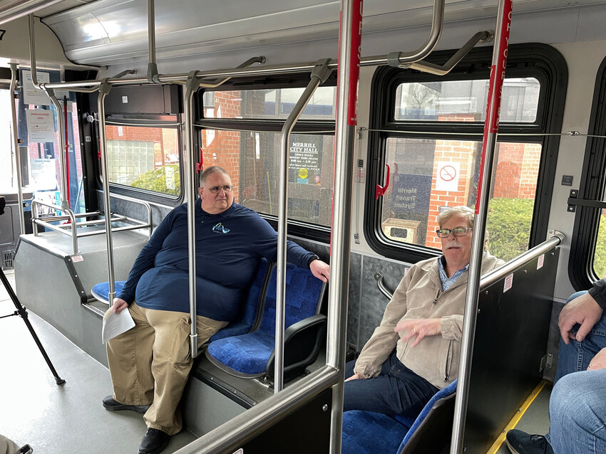 Mayor Steve Hass and Mike Ravn chat with other passengers about the history of the trolley and bus service in Merrill.