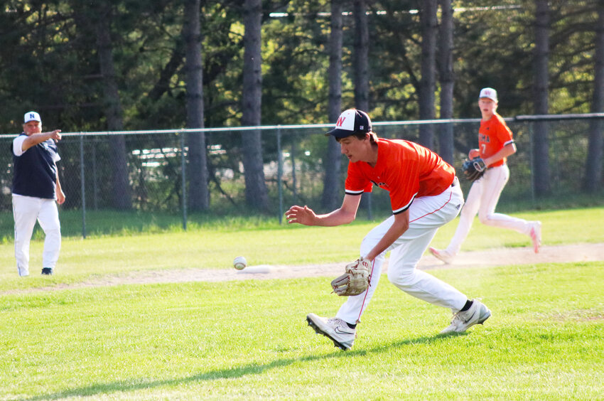 Peyton Pica gets ready to scoop up a low hit to throw over to first base.