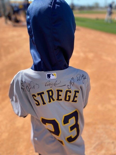 Some of the autographs Owen Strege of Algoma obtained on the back of his Milwaukee Brewers jersey while he was a guest of the team during its opening weekend of  spring training in Phoenix. Strege was one of three boys from Wisconsin with pediatric health issues chosen by Aurora Health Care to be guests of the team that weekend and meet players, tour the facilities and throw out the first pitch of the Brewers' opening spring training game Feb. 25.