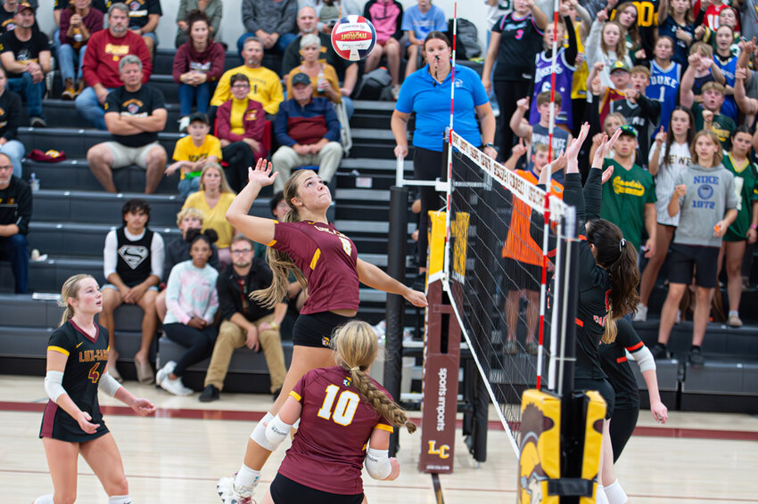Miranda Schmidt goes up for a kill against Oconto Falls