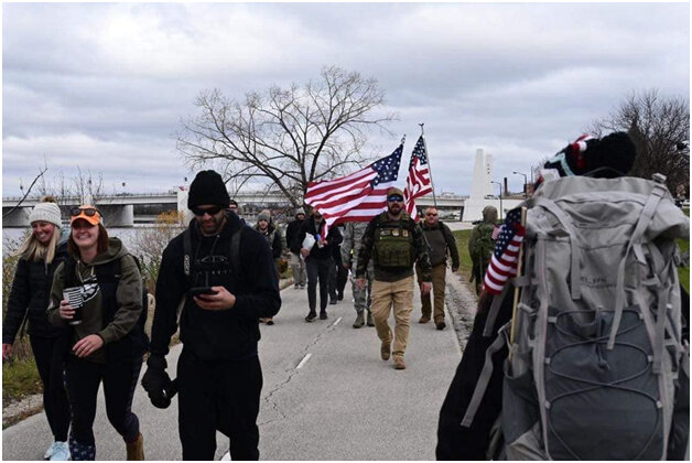 Participants from the 10th annual Veterans Awareness March walk along the trail alongside other veterans and community members. Submitted photo