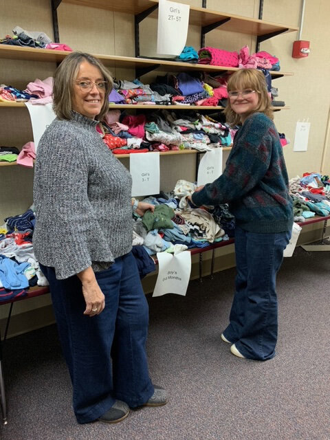 Two people sorting clothes