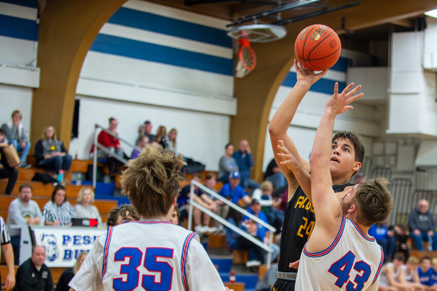 Algoma's Cody Kirchman gets to the bucket ahead of a Peshtigo double team on Friday, Dec. 8 as the Wolves defeated the Bulldogs. Josh Staloch photo
