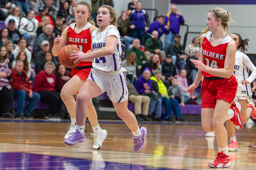 Kewaunee’s Braelyn Chevalier gets a step on a pair of Valders defenders on her way to the basket and two of her six points 