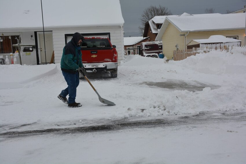 Stanley Johnson puts the finishing touches on his driveway on First Street.