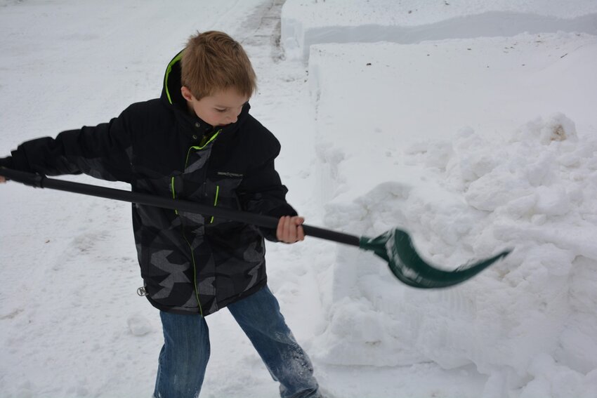 Connor Nienhuis helps shovel his grandmother's driveway in Kewaunee on Tuesday.
