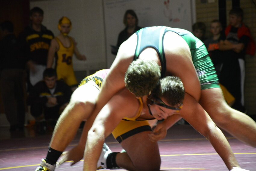 The Spartans heavyweight Phil Rasmussen battles Coleman's Donovan Salewski.