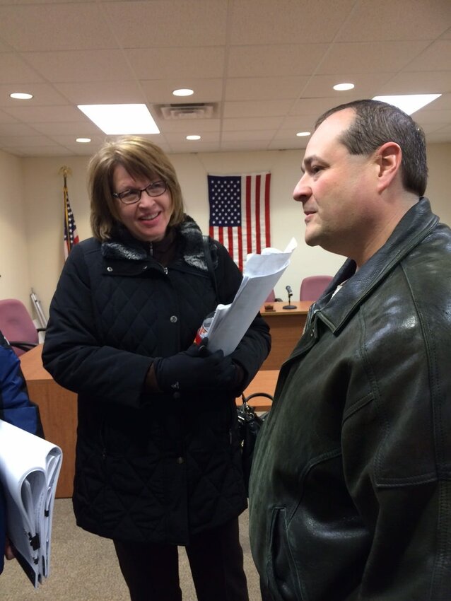 Diane Jirtle, Plan Vommission member, and Brian Vogeltanz, Kewaunee School Board president, discuss the permit approval after Monday's meeting.