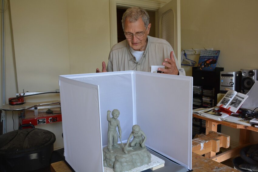 "We have a tourist and commercial fishing industry that should be preserved and that requires clean water," says Dr. William Faller with a model of a sculpture of Native American boys fishing he is creating for the City of Kewaunee.