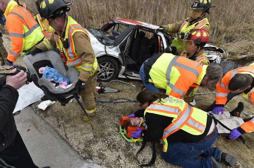 Algoma High School student Tyler Paplham is worked on by Kewaunee County fire and rescue during a program re-enacting a two-vehicle drunk driving accident Wednesday at Algoma High School. Paplham played one of the drivers injured in the crash.