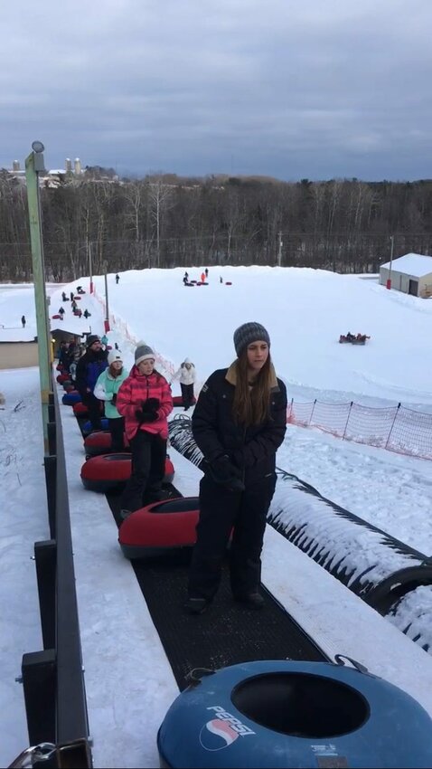 Snow tubing enthusiasts ride the Magic Carpet lift up the tubing hill at Winter Park in Kewaunee. The new stand-up lift is considered one of the reasons Winter Park, which is now closed for the season, set a new attendance record in 2017-18.