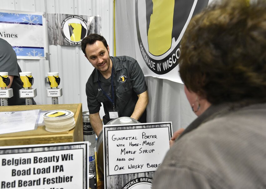 Ed Thiry of Thumb Knuckle Brewing Co., Walhain, pours a Gunmetal Porter with homemade maple syrup for a guest at the March 24 Roar off the Shore Brewfest.