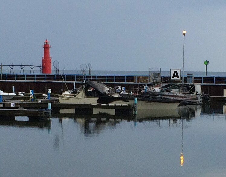 Damaged boats sit in Algoma Marina the morning of June 23 after an overnight recreational boat fire caused damage to five boats, three of which later sank. Sunrise Cove Marina is hosting a Blessing of the Fleet ceremony in Algoma on June 22.