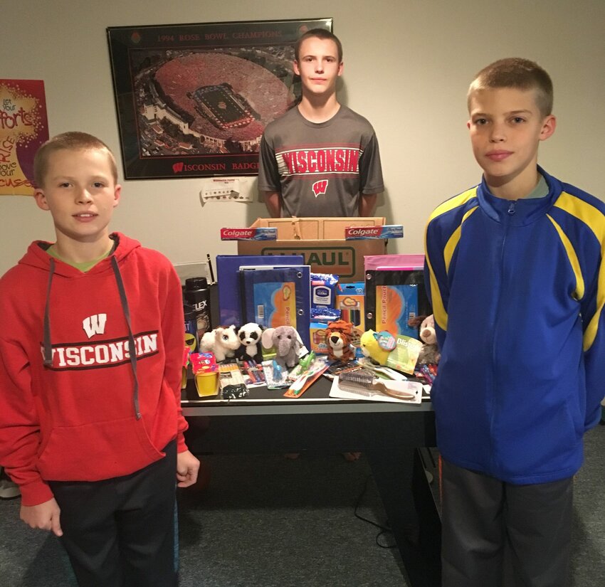 Christopher, James and Cameron Cullen, from left, are shown with some of the items collected through the Kid Comfort Pack drive they organized with their parents for the Kewaunee County Violence Intervention Project. It's the third different charity collection drive the brothers from Kewaunee have run.