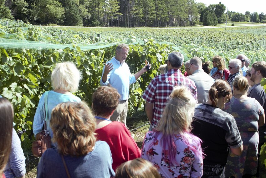 Parallel 44 Vineyard & Winery co-owner and winemaker Steve Johnson leads a tour at last year's Harvest Fest. This year's annual fall wine festival at Parallel 44 takes place Sept. 7.