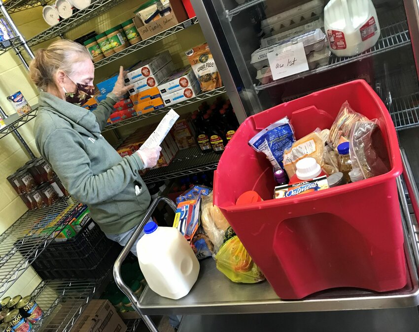 Volunteer Sheri Heidel fills a client's order at Lakeshore Community Pantry in Kewaunee.