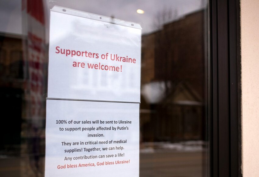 A sign of support to Ukrainians is taped to the front door of Wakker Cheese, Monday, March 7, 2022, at 409 Milwaukee St. in Kewaunee, Wis. Wakker Cheese is sending 100% of proceeds from all sales to Ukrainians amid the Russian invasion.