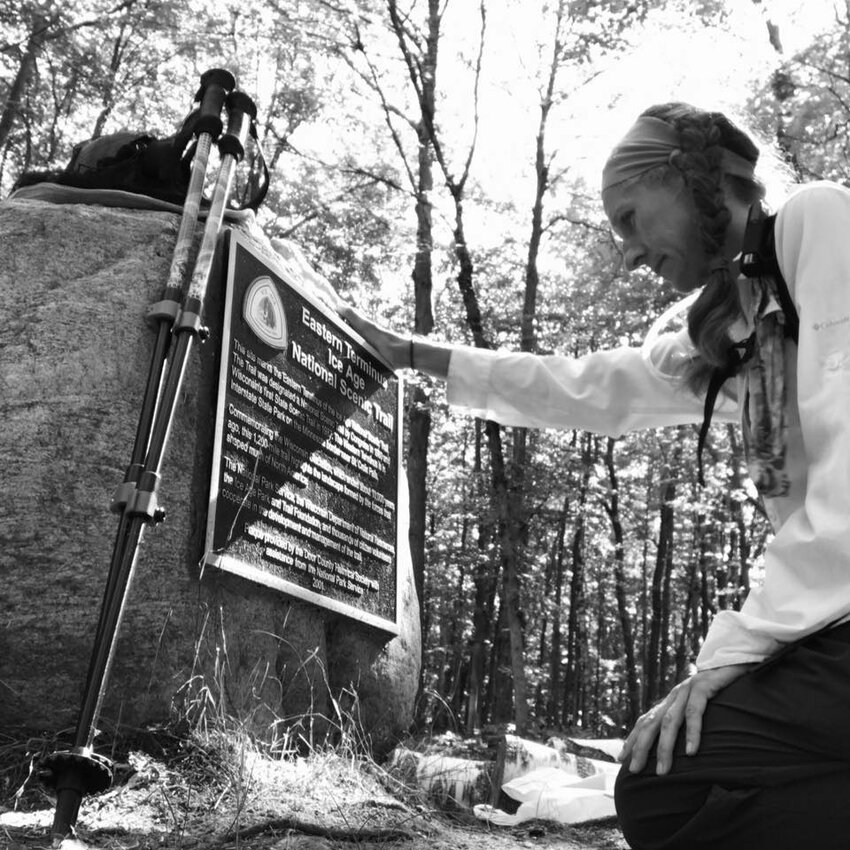 Kewaunee County native Laura Hinesh kneels at the eastern terminus of the Ice Age Trail in Potawatomi State Park in Sturgeon Bay after hiking the more than 1,000 miles of the trail in October of 2020. On Jan. 30, 2022, Hinesh completed the trail for a second time in Kewaunee County.