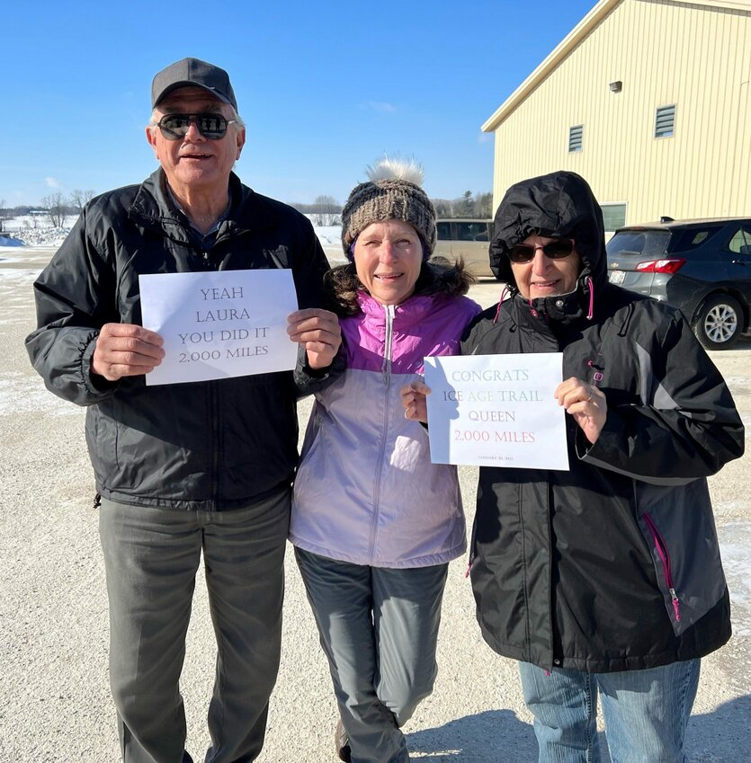 Kewaunee County native Laura Hinesh, center, poses with her parents, Lawrence Krummel, Sr., and Emily Krummel of Stangelville, outside Parallel 44 Vineyard & Winery in Kewaunee after Laura completed hiking the entire Ice Age Trail throughout Wisconsin to become a Thousand Miler for a second time.