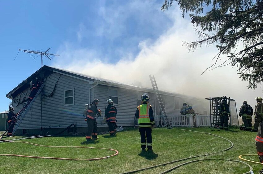 Firefighters from the Luxemburg Community Fire Department and five other area departments battle a house fire for about five hours May 7 in the town of Luxemburg.