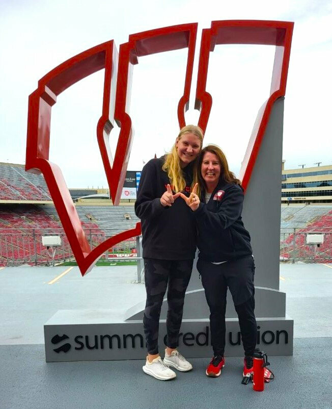 Ashwaubenon High School junior Berritt Herr, left, stands with University of Wisconsin-Madison softball coach Yvette Healy. Herr recently verbally committed to the play at Wisconsin. Submitted Photo