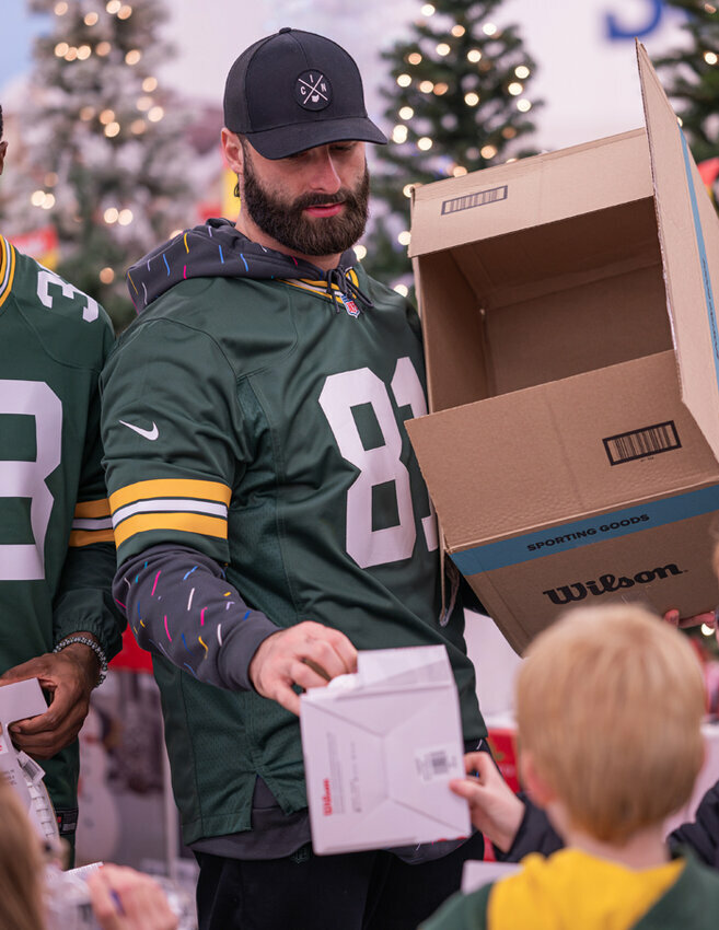 Green Bay Packers Tight End Josiah Deguara hands a signed football to a member of the Pals program. Shane Fitzsimmons photos