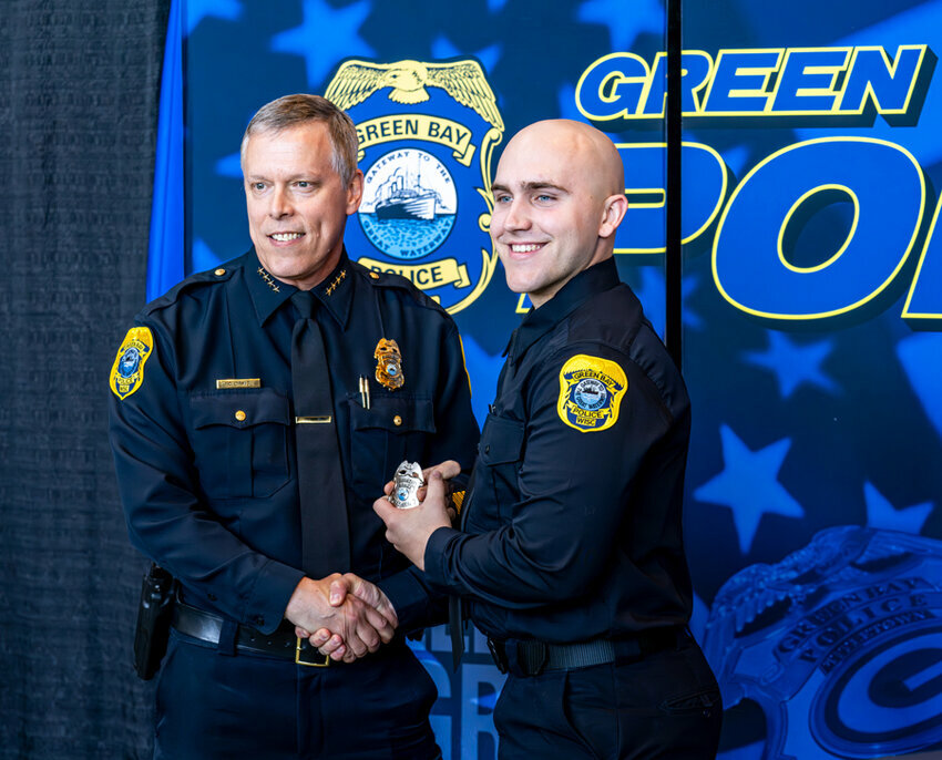 Patrol Officer Aaron Kopp, right, is sworn in. Kopp is pictured with GBPD Chief Chris Davis