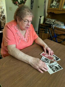 June Muller looks over photos of the St. Joseph's Orphanage as she recalls her time there. Kris Leonhardt photo