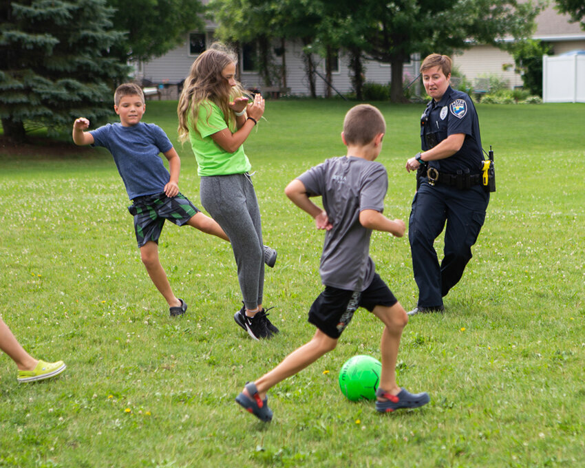 Officer Melissa Vande Wettering enjoyed a game of soccer with local children at Kiwanis Park. Andrew Pantzlaff photo