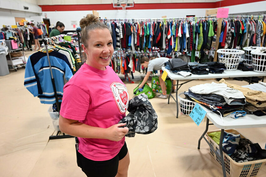 Erica Hennig, St. Mark partner, volunteers as the St. Mark Lutheran School gym is transformed into a makeshift sales floor. Eva Westein photo