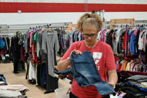 Kim Wismer folds a pair of pants for this year's clothing giveaway which will be held Aug. 2-3, 8 a.m. - 2 p.m., at St. Mark Lutheran Church and School’s Green Bay campus.  Eva Westein photo