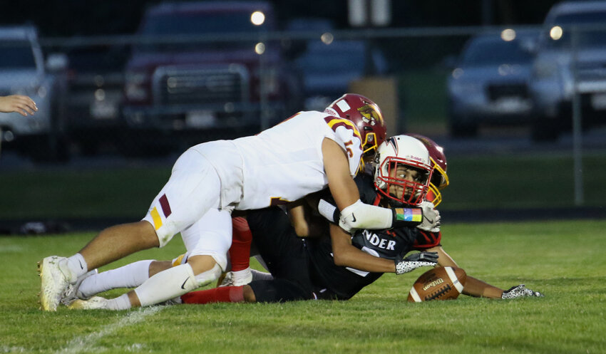 Seymour's Johnny Ramirez gets tackled after picking up a loose ball.